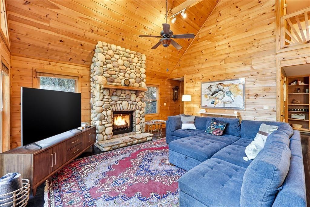 834 Indian Cave Road Ellijay, GA 30536 - Photo 10 of 44 a living room with furniture and a flat screen tv