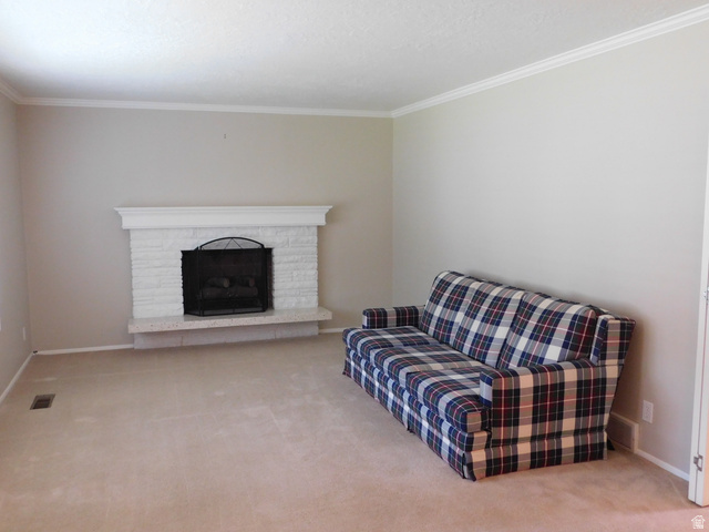 2148 Carolyn Way Bountiful, UT 84010 - Photo 2 of 40 Living area featuring a painted brick fireplace with a white mantel and a stone hearth