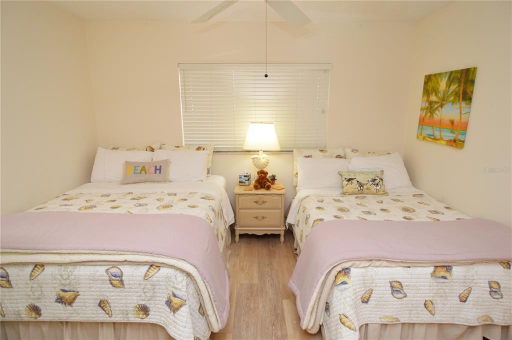 900 Gulf Boulevard, Unit 907 Indian Rocks Beach, FL 33785 - Photo 51 of 88 a bedroom with a bed and wooden floor