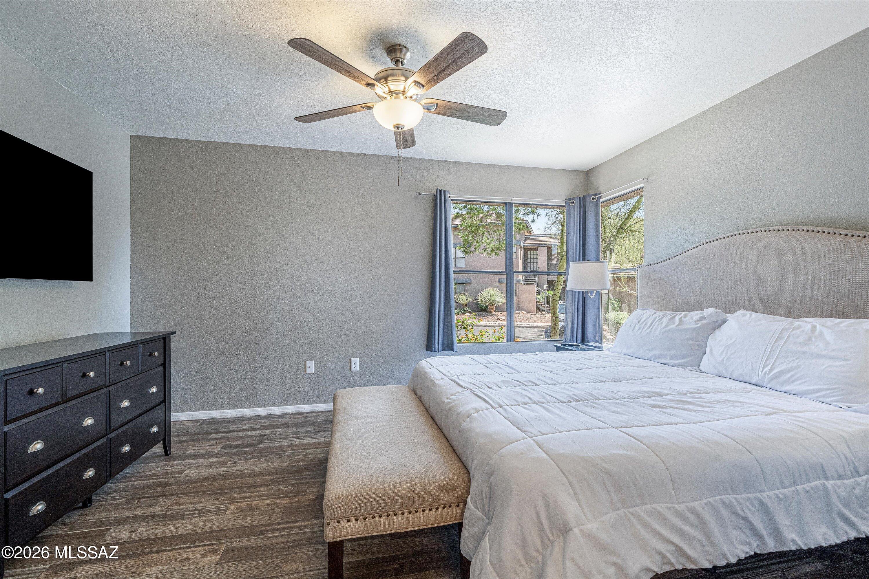 5855 North Kolb Road, Unit 8106 Tucson, AZ 85750 - Photo 19 of 34 a bedroom with a bed a window and a flat screen television
