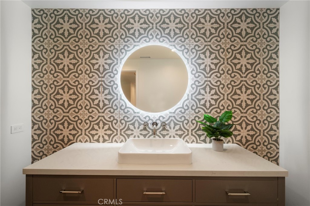 7337 La Soldadera Rancho Santa Fe, CA 92067 - Photo 22 of 60 wooden floor with a sink and a mirror