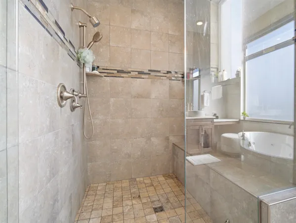 a bathroom with a granite countertop shower