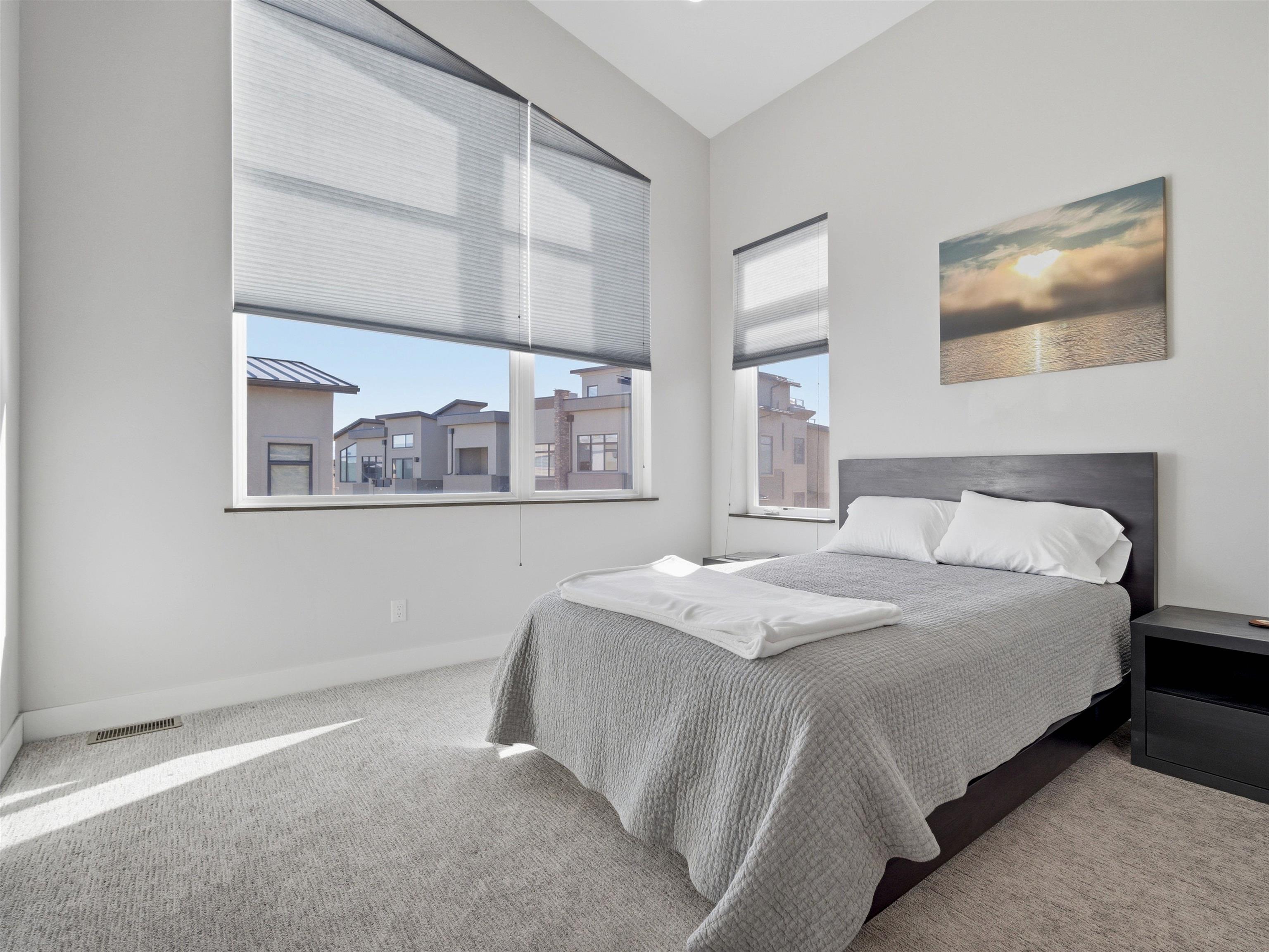 380 West Ridges Boulevard, Unit A Grand Junction, CO 81507 - Photo 22 of 41 a bedroom with a bed and a painting on the wall