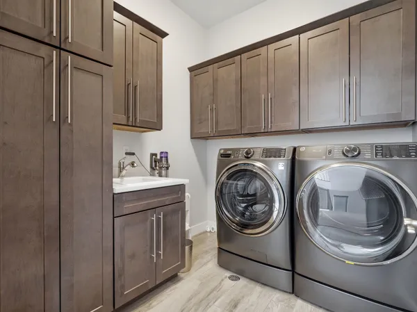 a utility room with sink dryer and washer