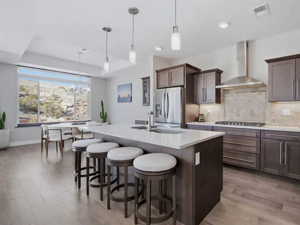a kitchen with a table and chairs in it