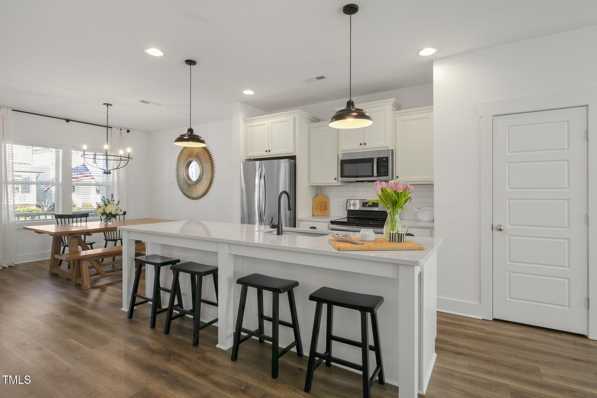 237 Daniel Ridge Road Wendell, NC 27591 - Photo 10 of 41 a kitchen with kitchen island a dining table and chairs
