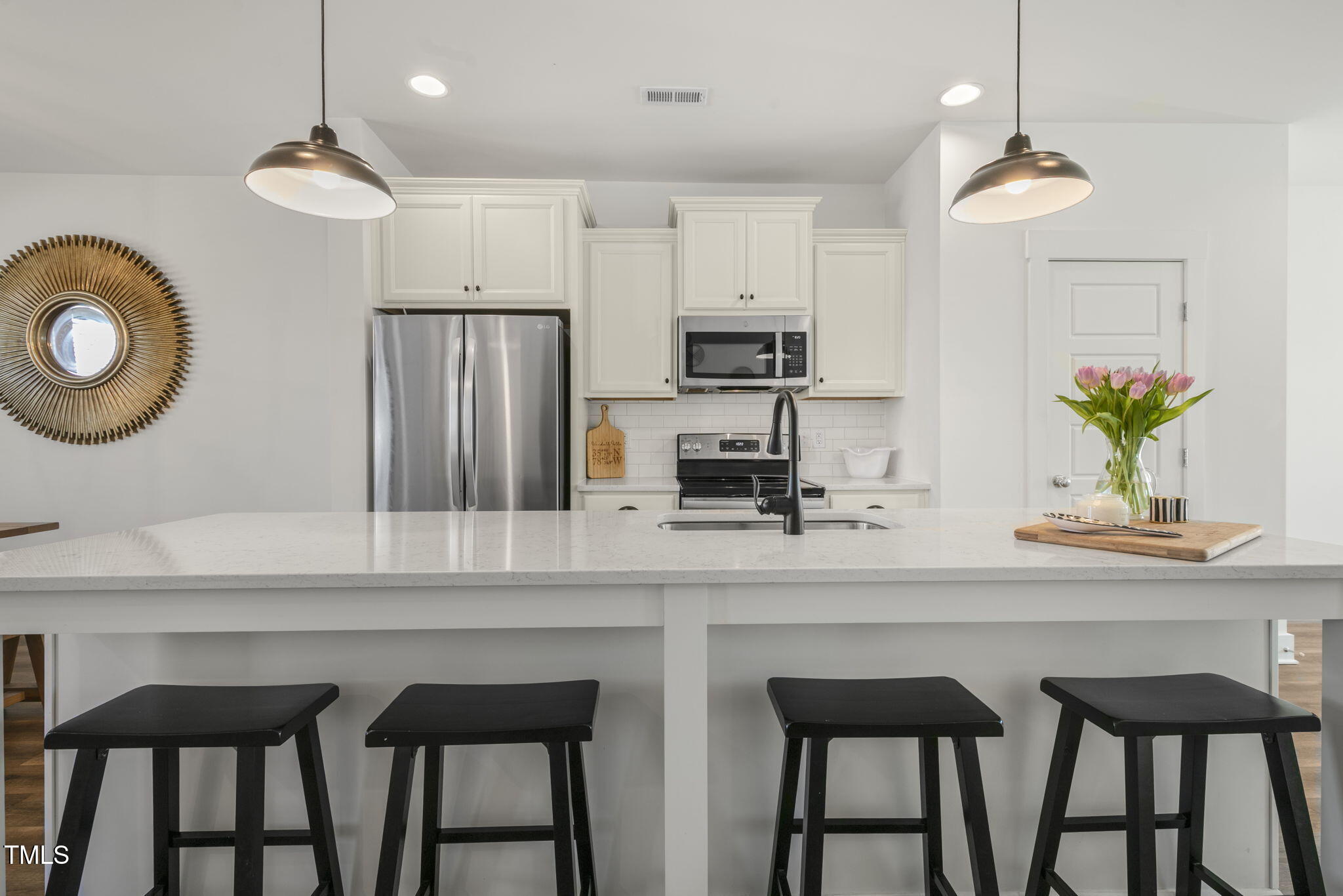 237 Daniel Ridge Road Wendell, NC 27591 - Photo 11 of 41 a kitchen with stainless steel appliances granite countertop a table chairs stove and microwave