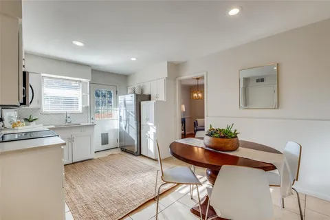 a kitchen with a refrigerator and a stove top oven