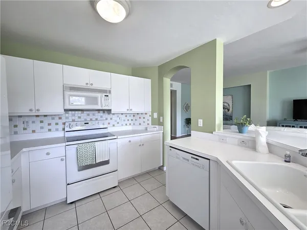 a kitchen with sink cabinets and stove