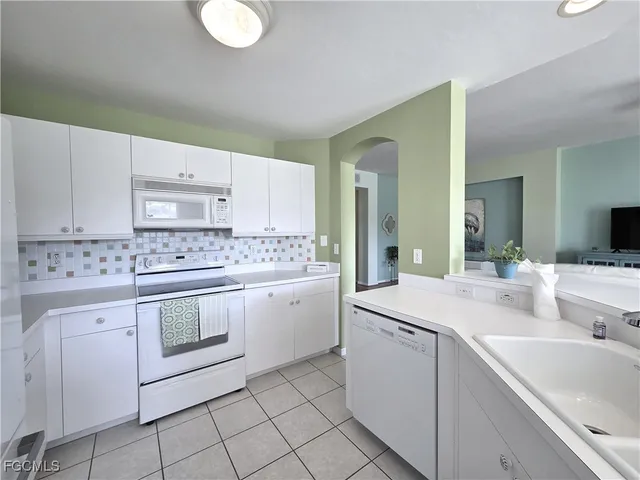a kitchen with sink cabinets and stove
