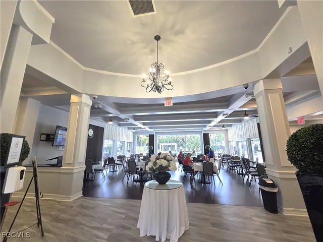 a kitchen with a table chairs stove and cabinets