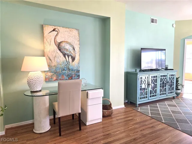 a dining room with furniture and wooden floor