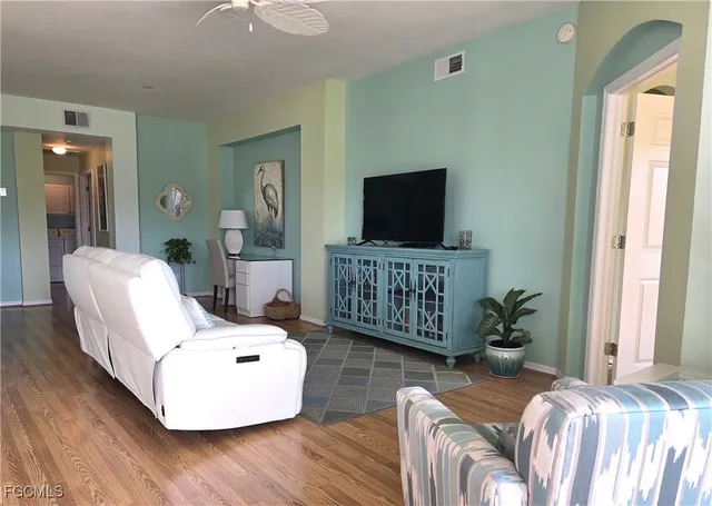 a living room with furniture and a flat screen tv