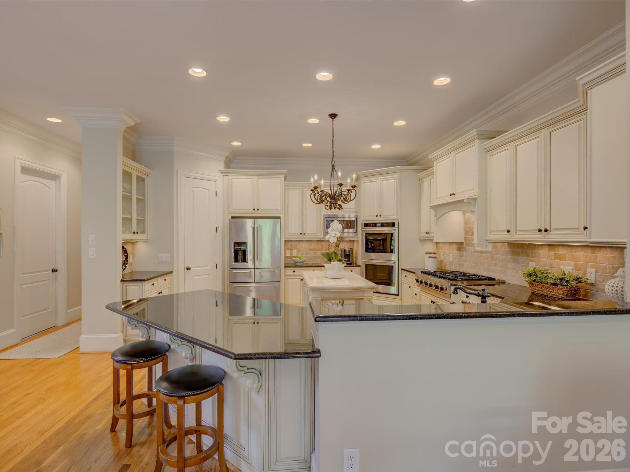 5060 Carmel Road Charlotte, NC 28226 - Photo 12 of 46 a kitchen with stainless steel appliances granite countertop a sink and a refrigerator