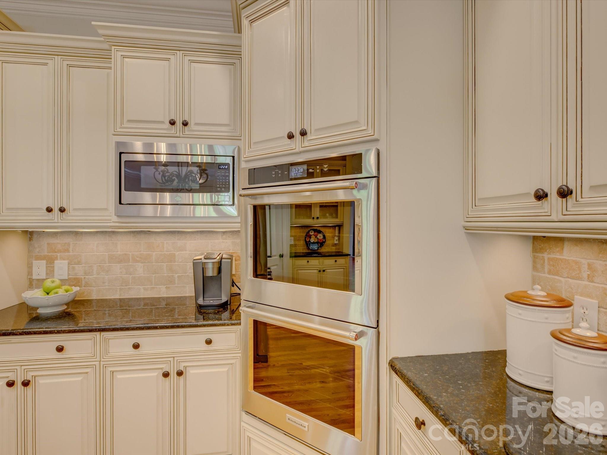 5060 Carmel Road Charlotte, NC 28226 - Photo 14 of 46 a kitchen with stainless steel appliances granite countertop a stove a microwave and cabinets