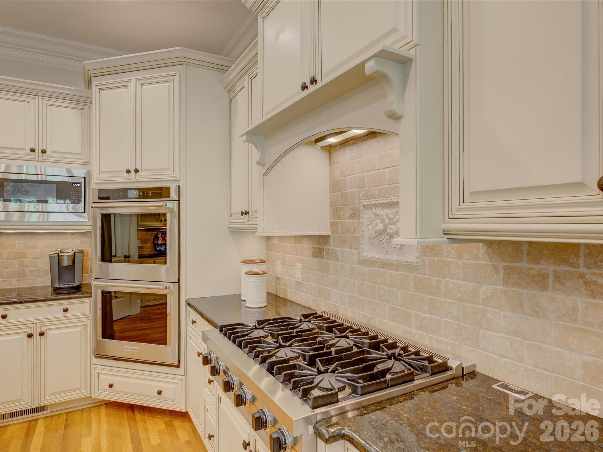 5060 Carmel Road Charlotte, NC 28226 - Photo 15 of 46 a kitchen with granite countertop a stove and white cabinets