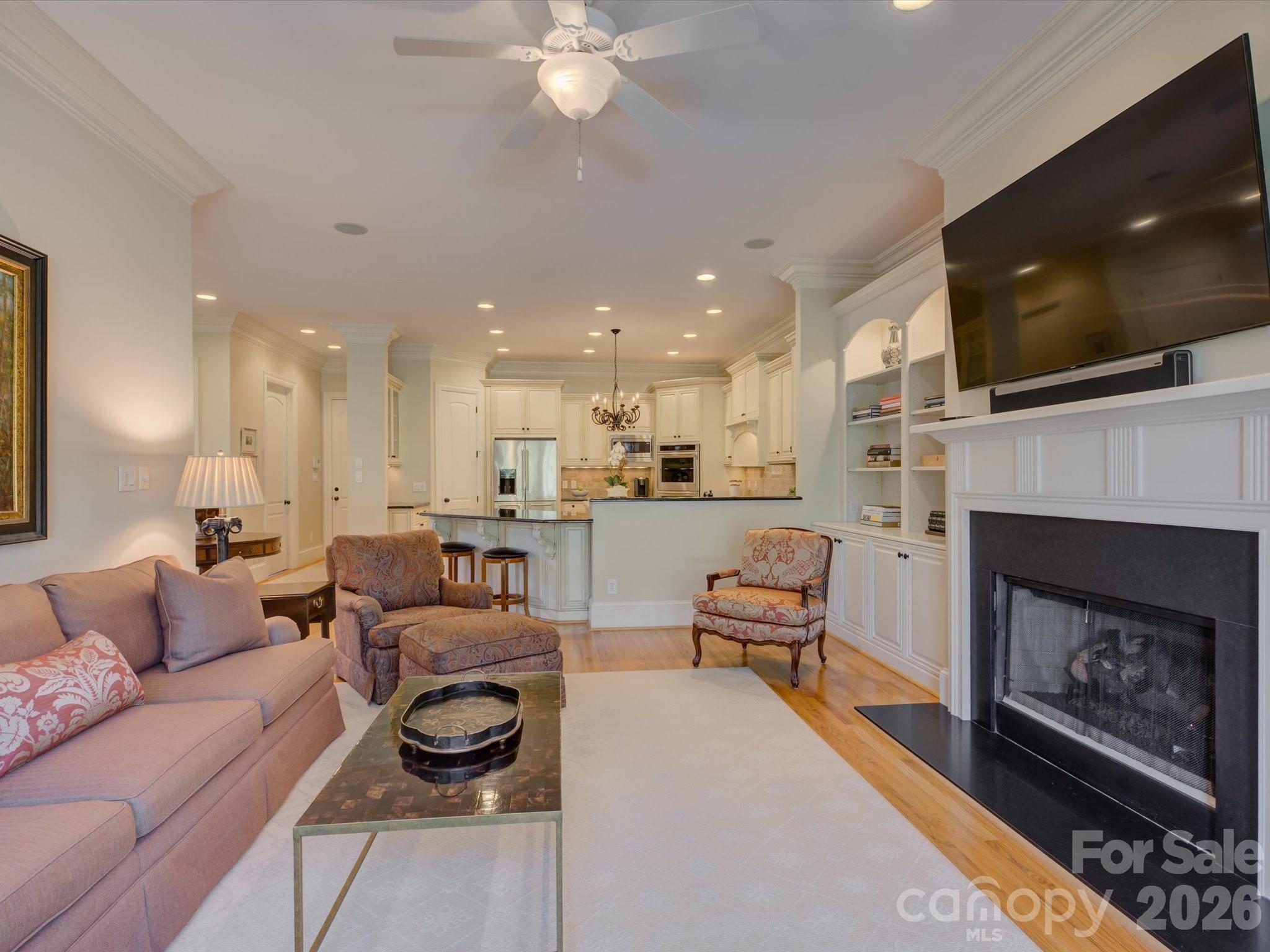 5060 Carmel Road Charlotte, NC 28226 - Photo 16 of 46 a living room with furniture a flat screen tv and a fireplace