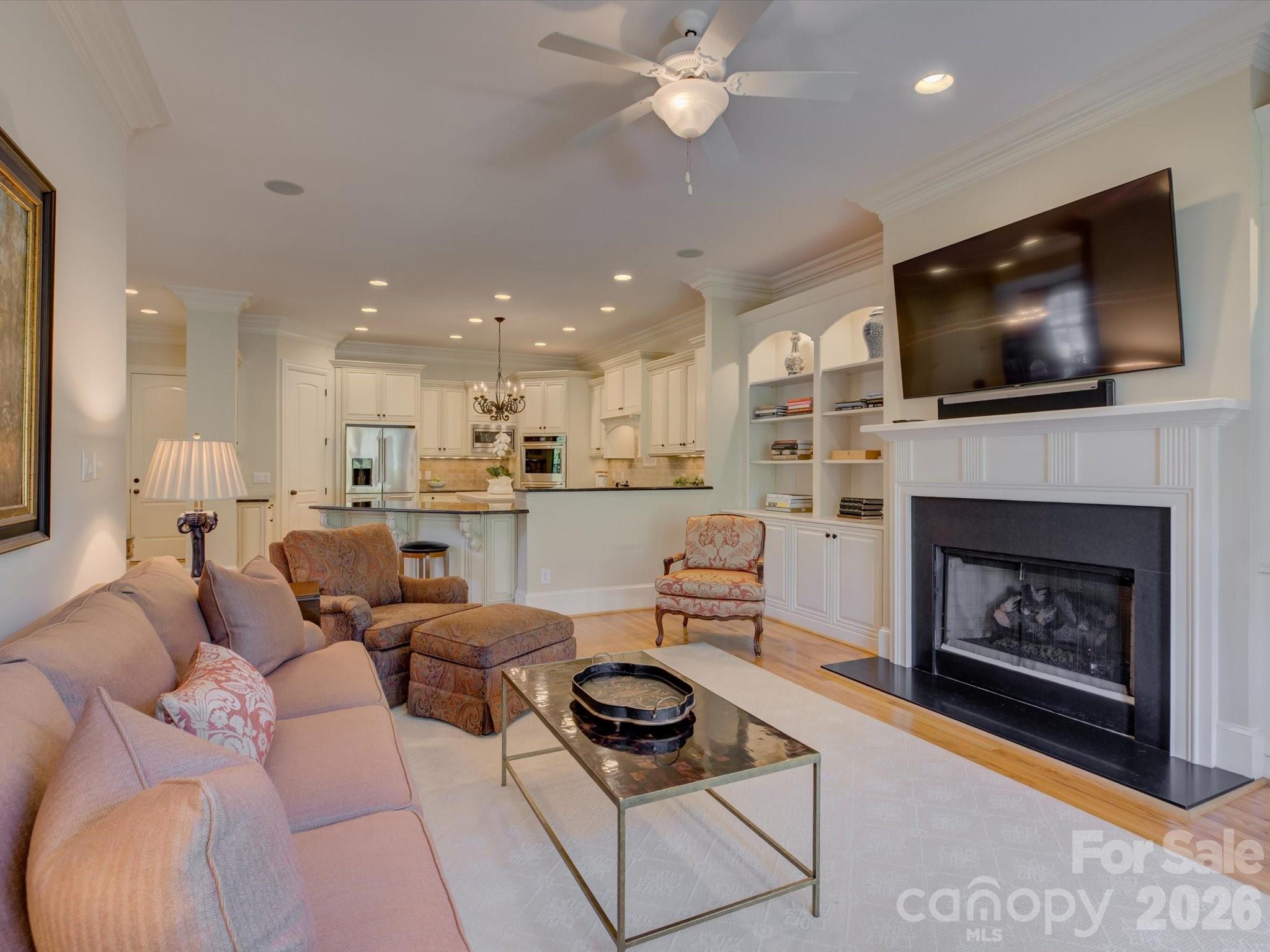 5060 Carmel Road Charlotte, NC 28226 - Photo 17 of 46 a living room with furniture a flat screen tv and a fireplace