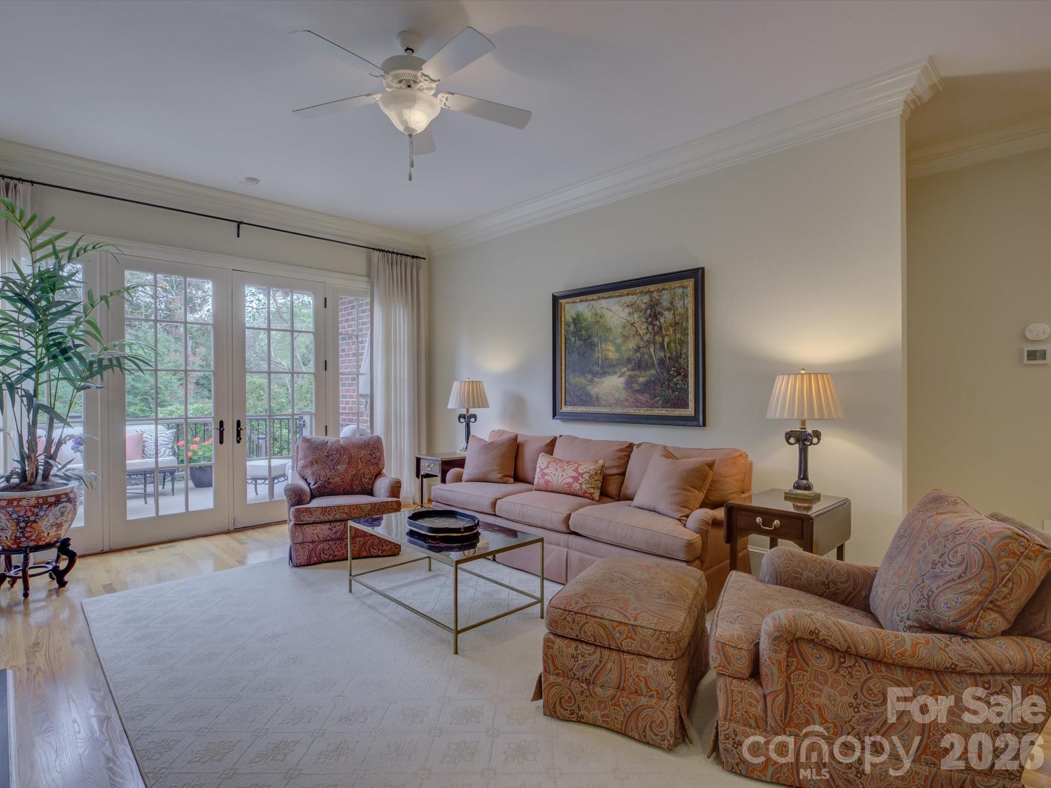 5060 Carmel Road Charlotte, NC 28226 - Photo 19 of 46 a living room with furniture and a large window with potted plants
