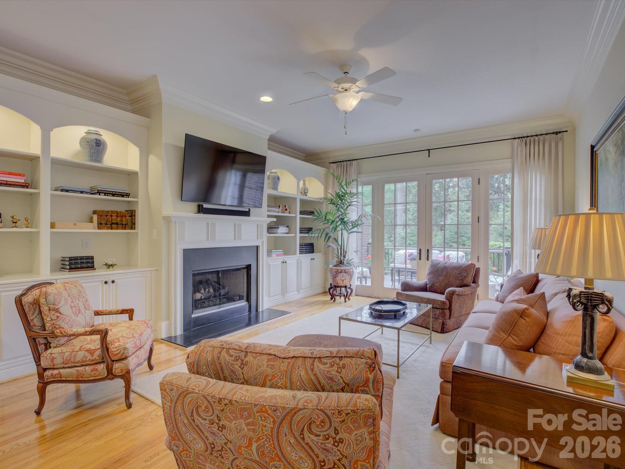5060 Carmel Road Charlotte, NC 28226 - Photo 20 of 46 a living room with furniture a fireplace and a flat screen tv