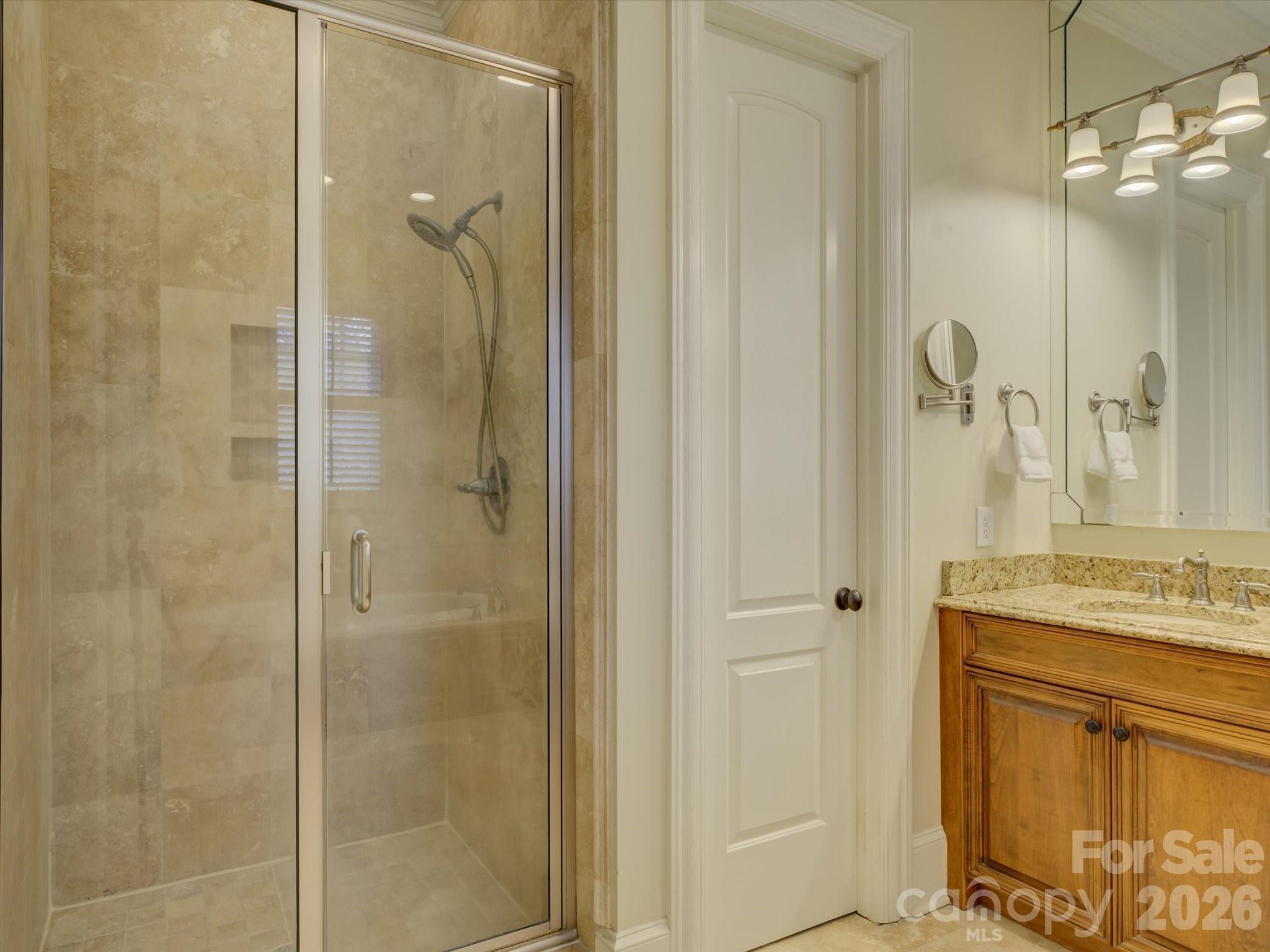 5060 Carmel Road Charlotte, NC 28226 - Photo 24 of 46 a bathroom with a granite countertop shower sink vanity and mirror