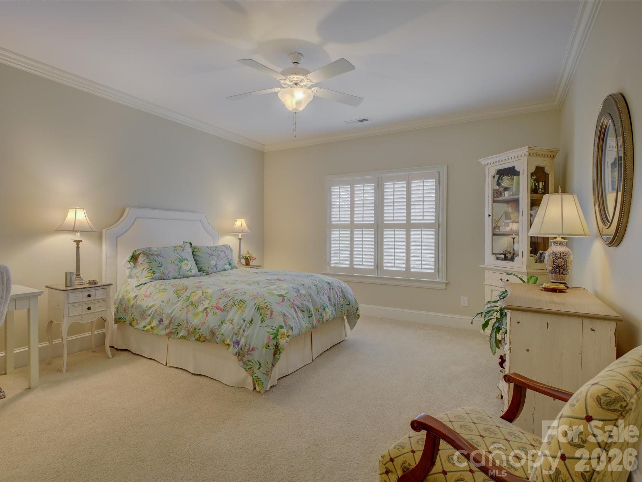 5060 Carmel Road Charlotte, NC 28226 - Photo 29 of 46 a spacious bedroom with a bed a couch and large windows