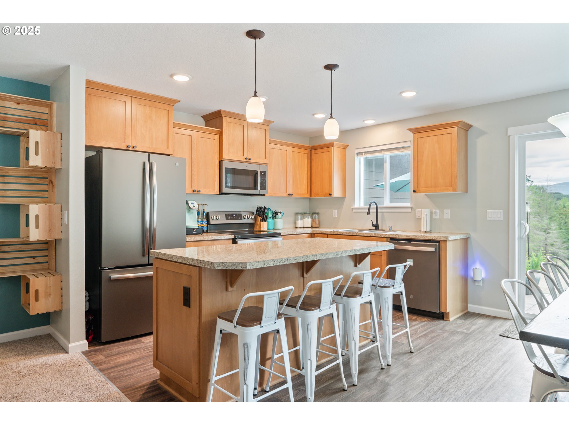 130 Grand Ridge Road Toutle, WA 98649 - Photo 5 of 34 a kitchen with stainless steel appliances granite countertop a refrigerator a sink a stove a dining table and chairs