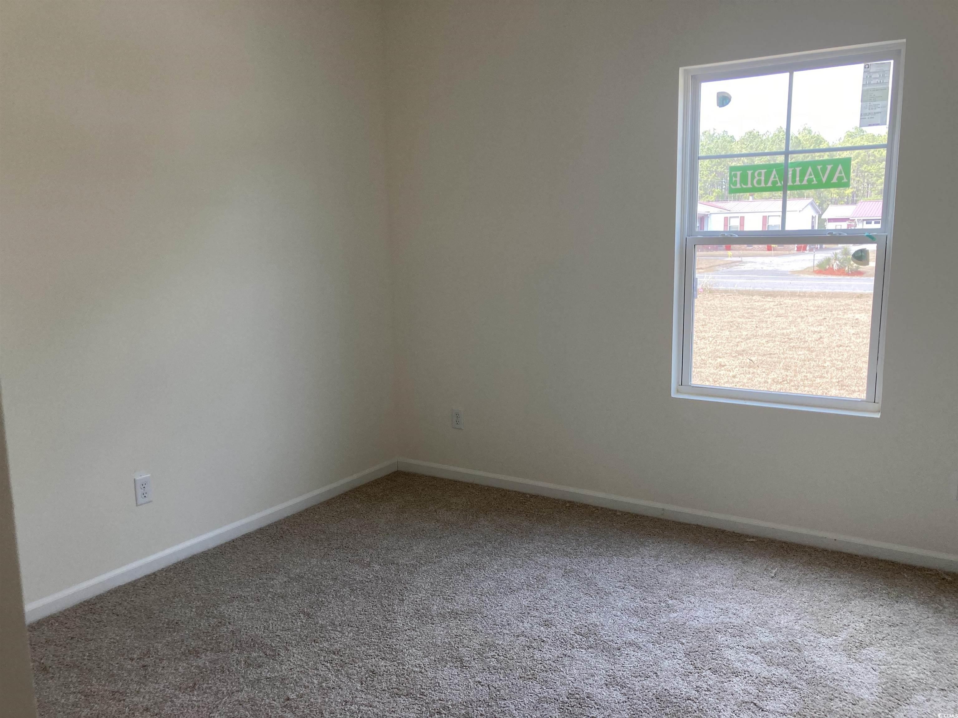 1060 Log Cabin Road Loris, SC 29569 - Photo 13 of 32 Carpeted empty room featuring baseboards