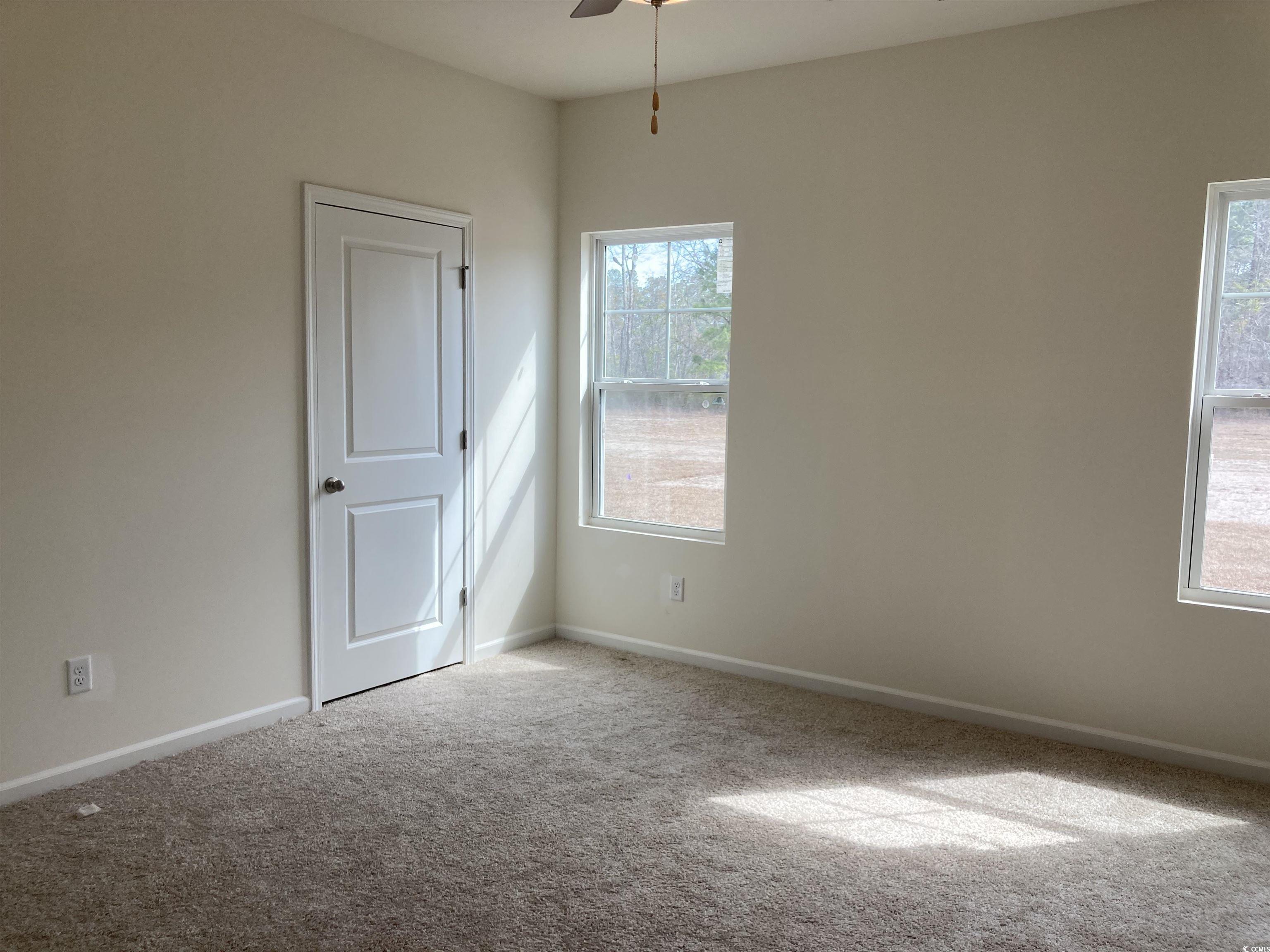 1060 Log Cabin Road Loris, SC 29569 - Photo 9 of 32 Carpeted spare room featuring ceiling fan and base