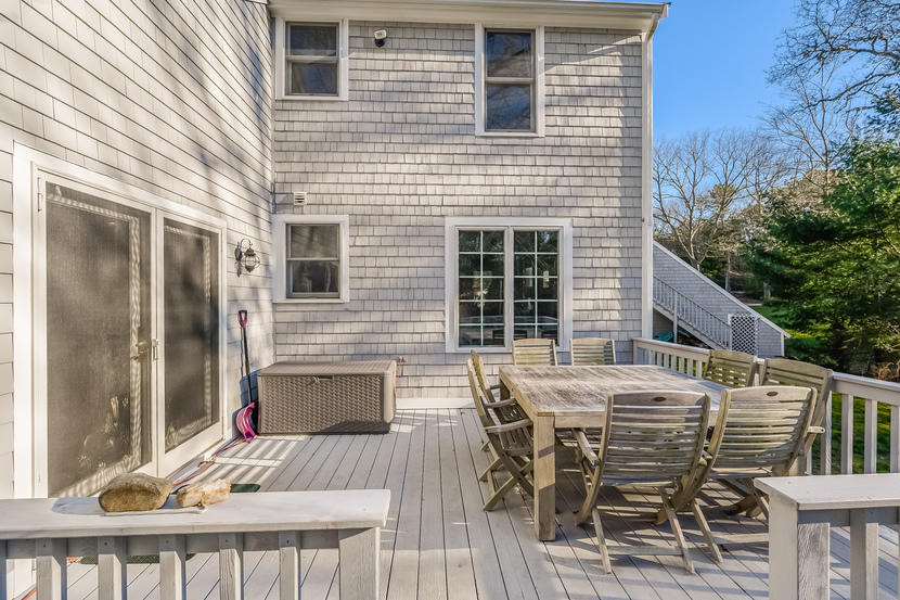 151 Peach Tree Road Marstons Mills, MA 02648 - Photo 10 of 49 a view of a patio with table and chairs with wooden floor and fence
