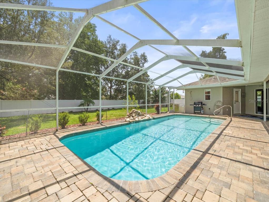 a view of a backyard with swimming pool
