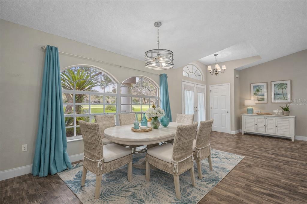 14717 Linden Drive Spring Hill, FL 34609 - Photo 17 of 29 a view of a dining room with furniture wooden floor and a chandelier