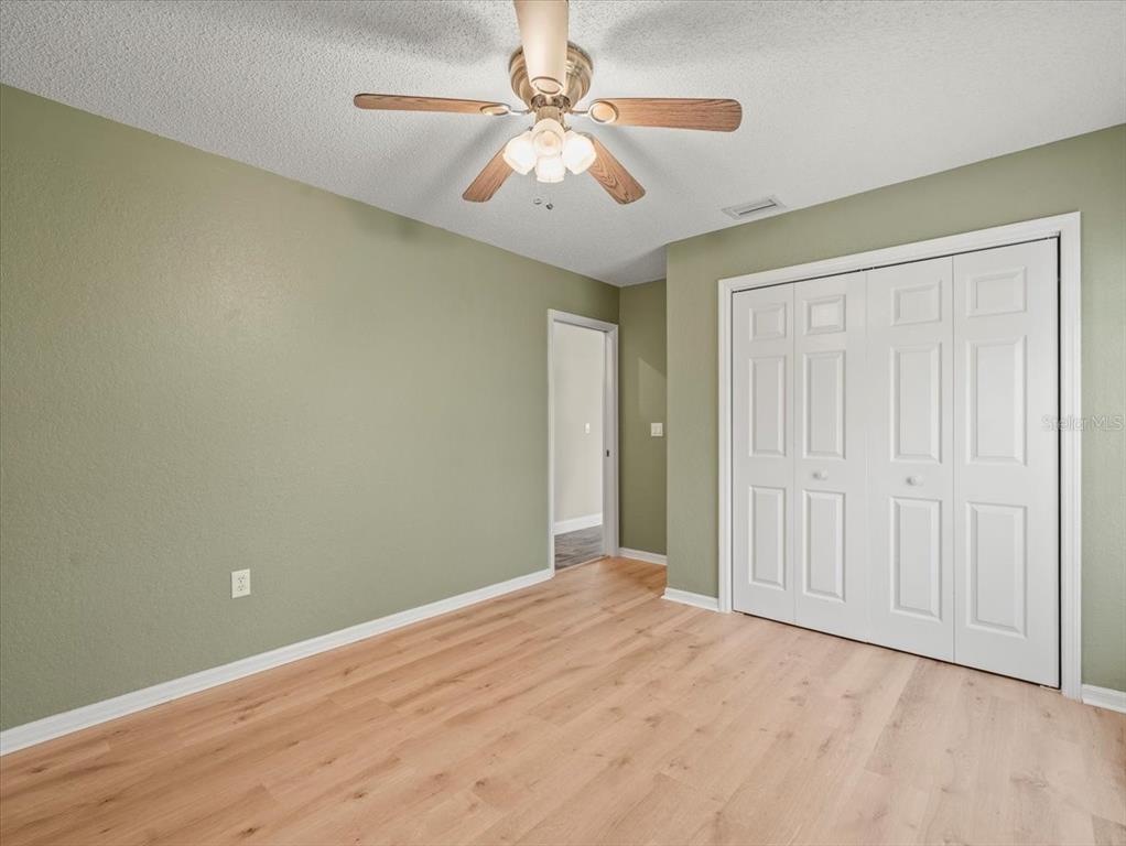14717 Linden Drive Spring Hill, FL 34609 - Photo 20 of 29 an empty room with a ceiling fan and a window
