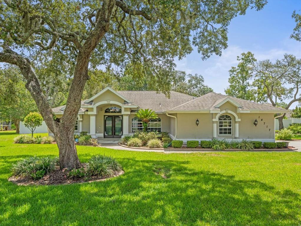 14717 Linden Drive Spring Hill, FL 34609 - Photo 2 of 29 a front view of house with yard and green space