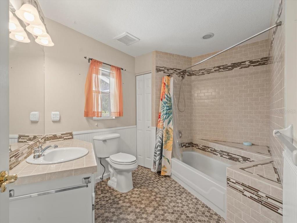 14717 Linden Drive Spring Hill, FL 34609 - Photo 22 of 29 a bathroom with a sink toilet and shower