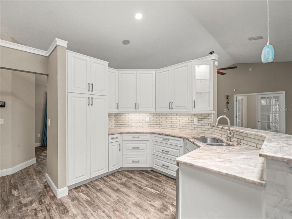 14717 Linden Drive Spring Hill, FL 34609 - Photo 6 of 29 a kitchen with a sink stove and refrigerator