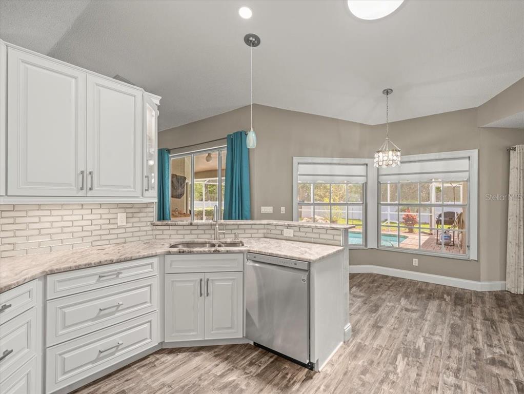 14717 Linden Drive Spring Hill, FL 34609 - Photo 8 of 29 a kitchen with granite countertop white cabinets and white appliances