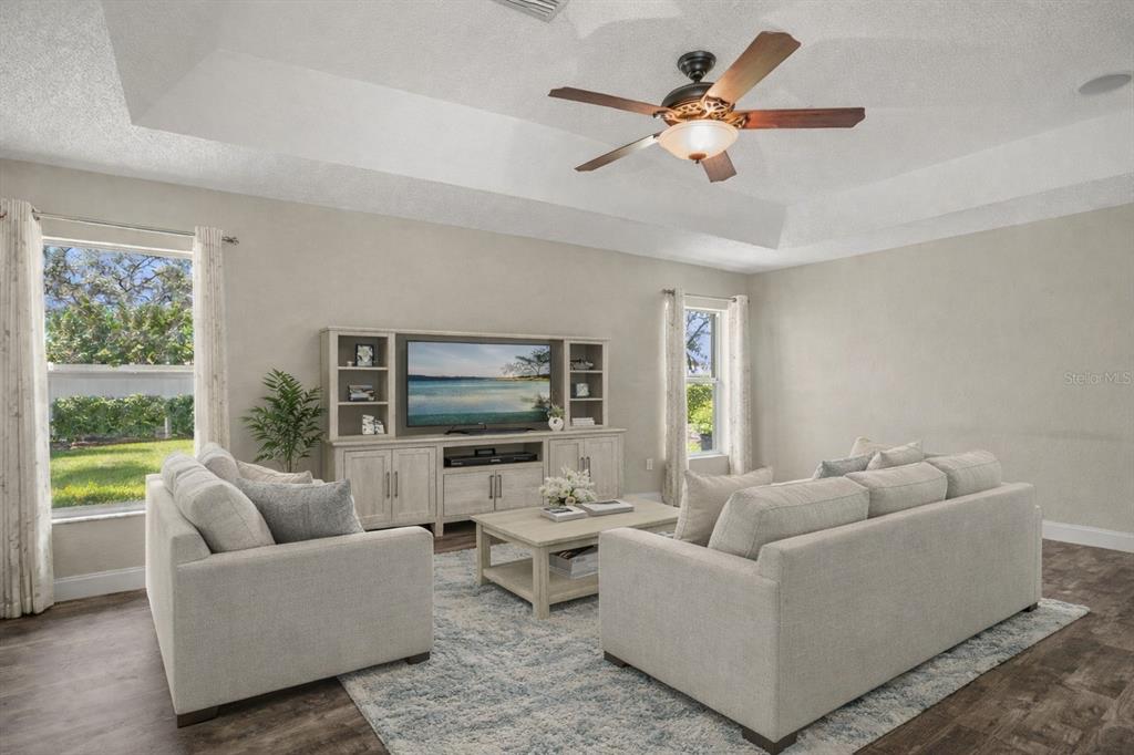 14717 Linden Drive Spring Hill, FL 34609 - Photo 10 of 29 a living room with furniture and a flat screen tv