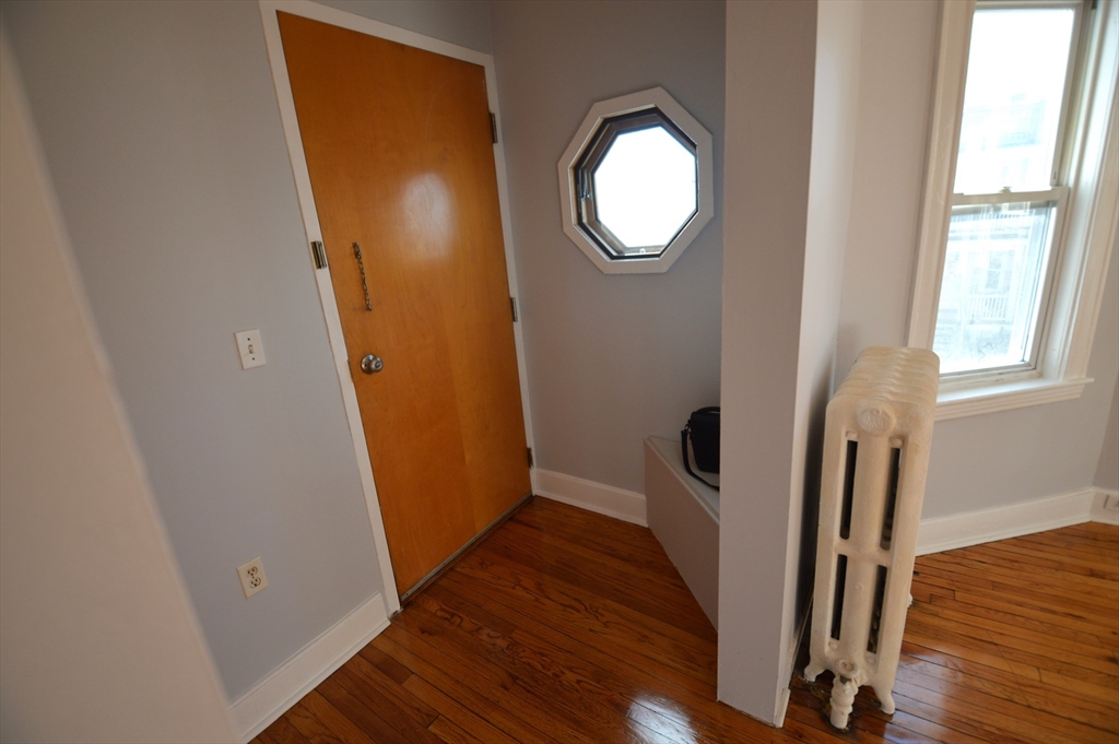 32 Stellman Road, Unit 2 Boston, MA 02131 - Photo 16 of 16 a view of a hallway with wooden floor and entryway