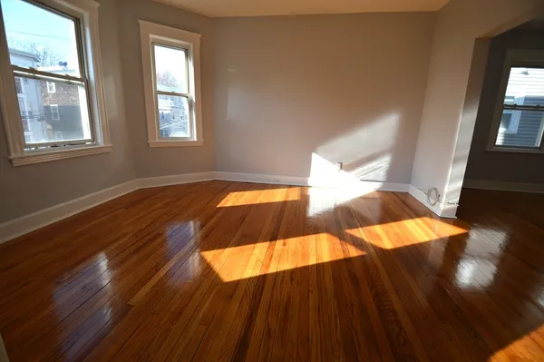 a view of an empty room and wooden floor
