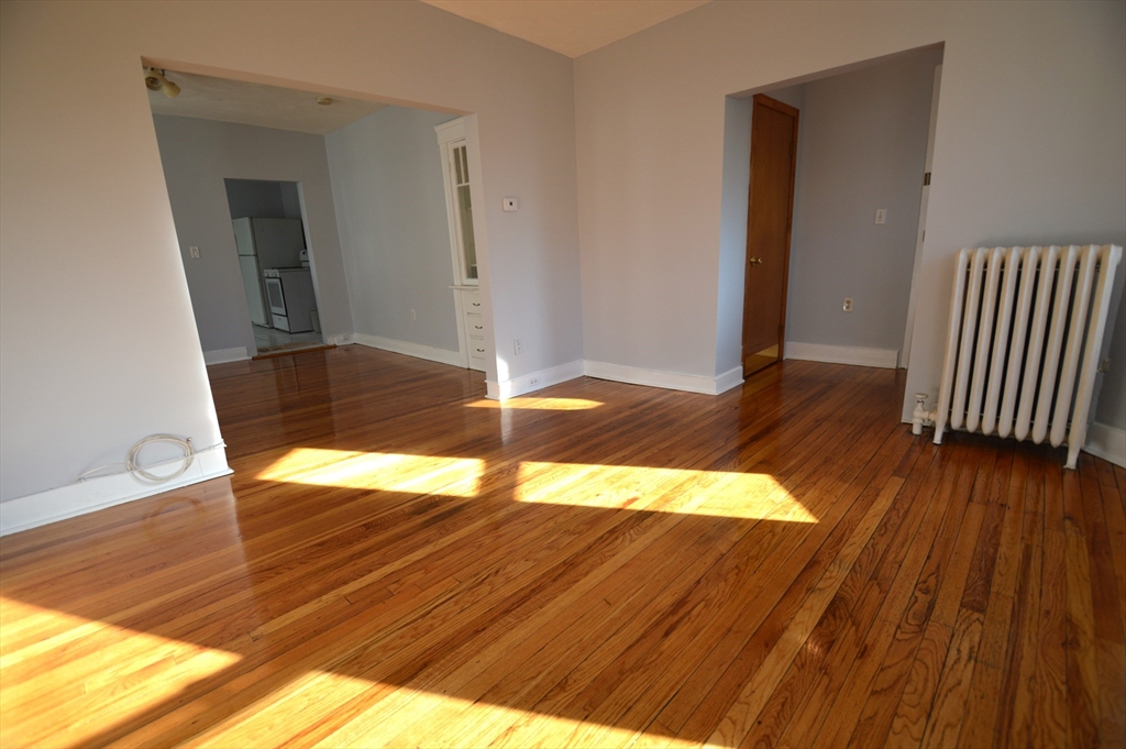 32 Stellman Road, Unit 2 Boston, MA 02131 - Photo 4 of 16 a view of empty room with wooden floor
