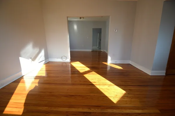 a view of wooden floor and a bathroom