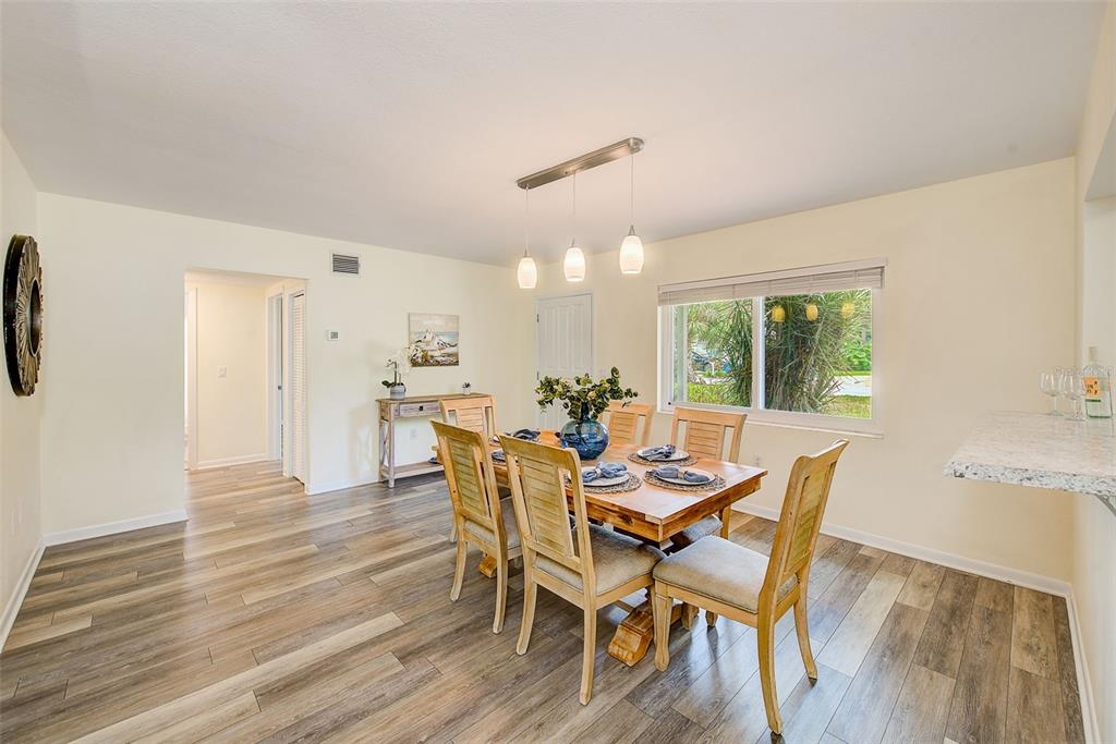 14079 Victoria Road Largo, FL 33774 - Photo 7 of 46 a view of a dining room with furniture and wooden floor