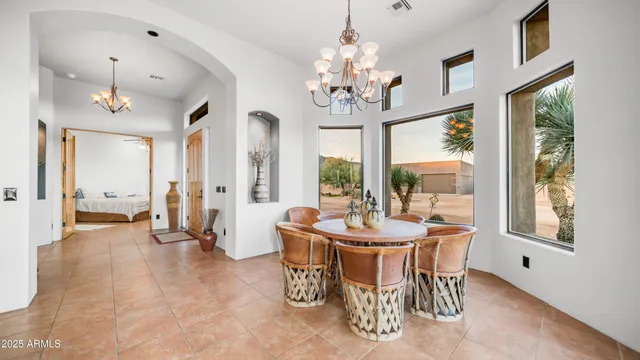 a bedroom with a large bed and a chandelier