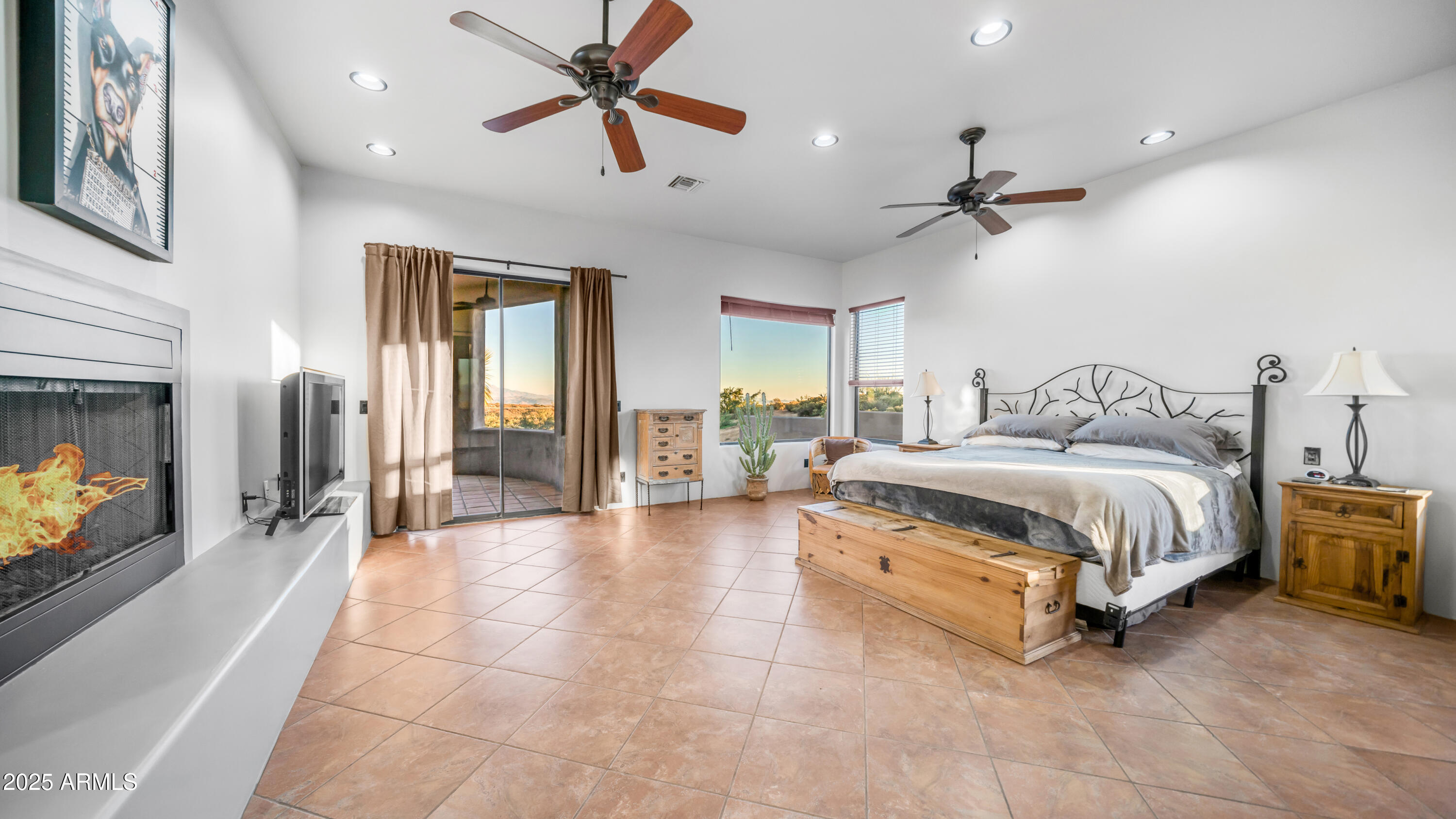 42215 North La Plata Road Scottsdale, AZ 85262 - Photo 20 of 93 a spacious bedroom with a bed a couch and a ceiling fan