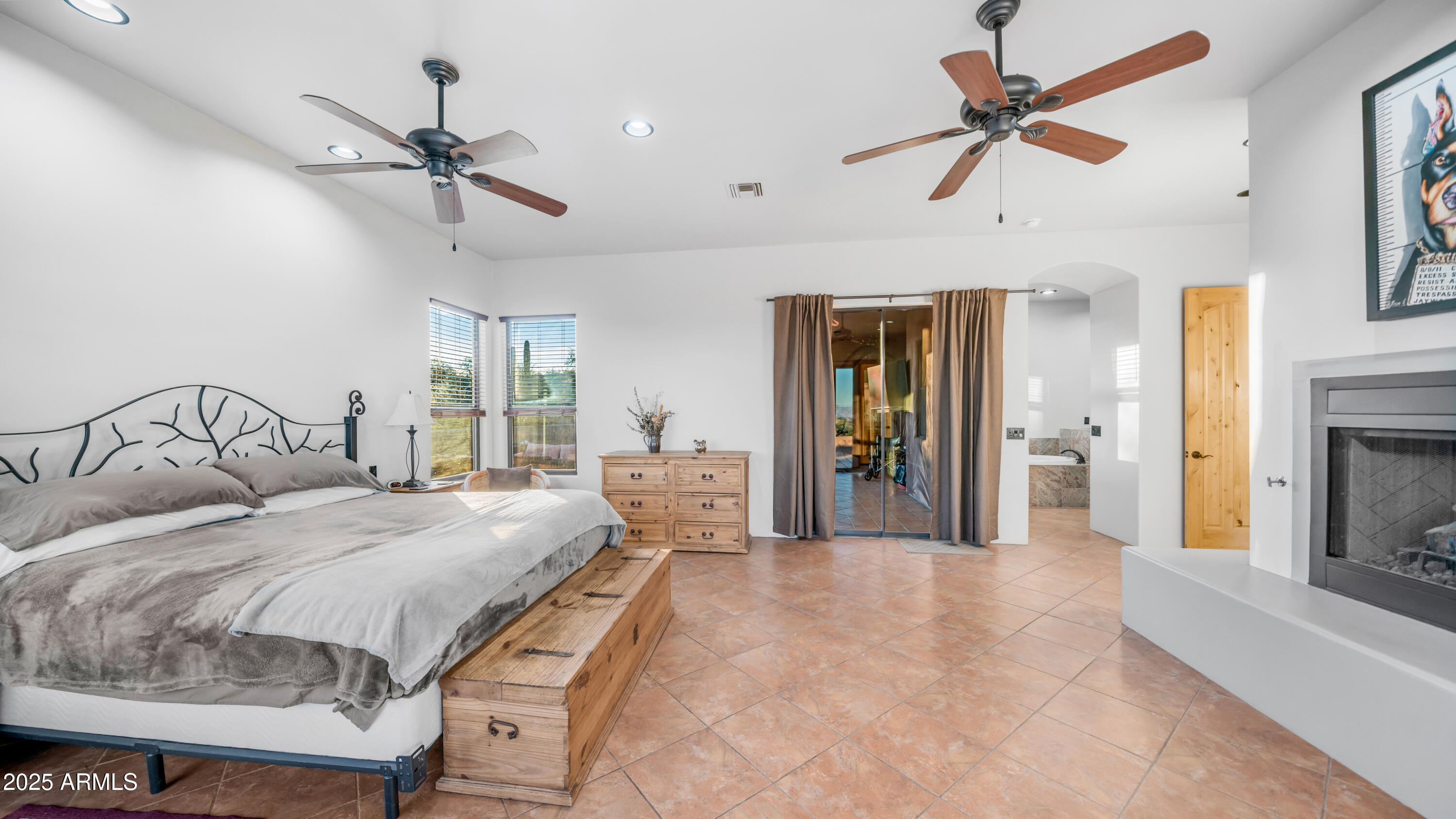 42215 North La Plata Road Scottsdale, AZ 85262 - Photo 22 of 93 a bedroom with a large bed and a chandelier