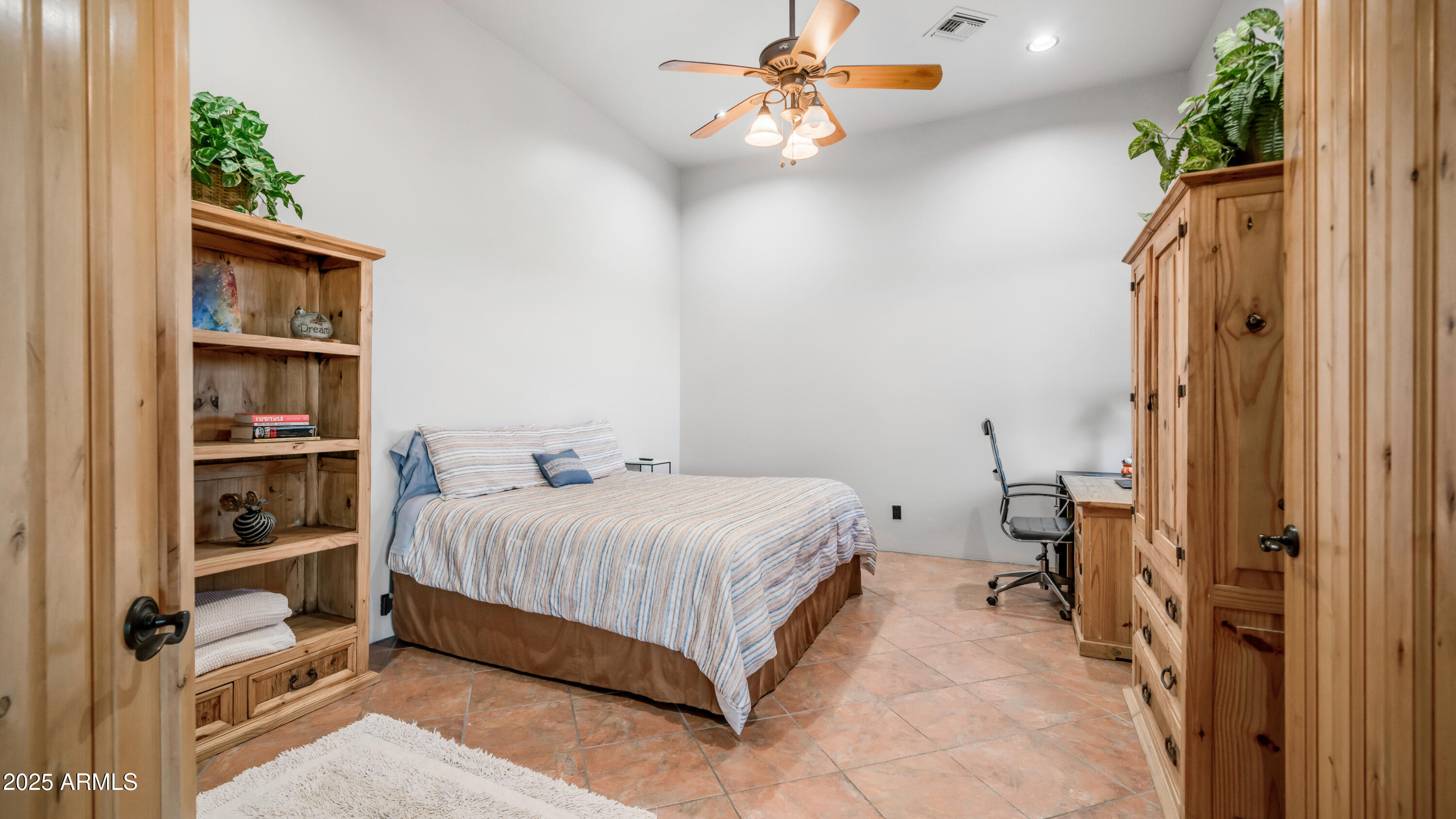 42215 North La Plata Road Scottsdale, AZ 85262 - Photo 32 of 93 a bedroom with a bed and a book shelf
