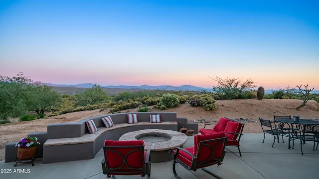 a view of a house with backyard and sitting area