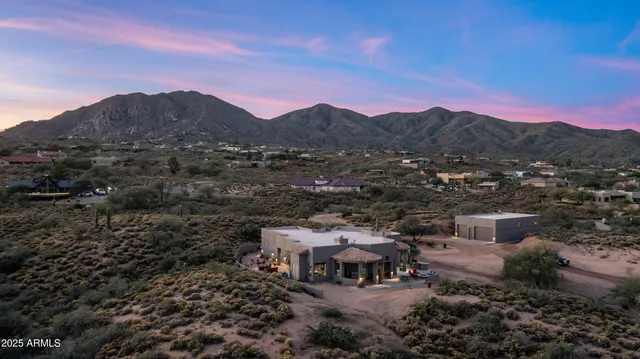 a kitchen with granite countertop a refrigerator and a counter top space