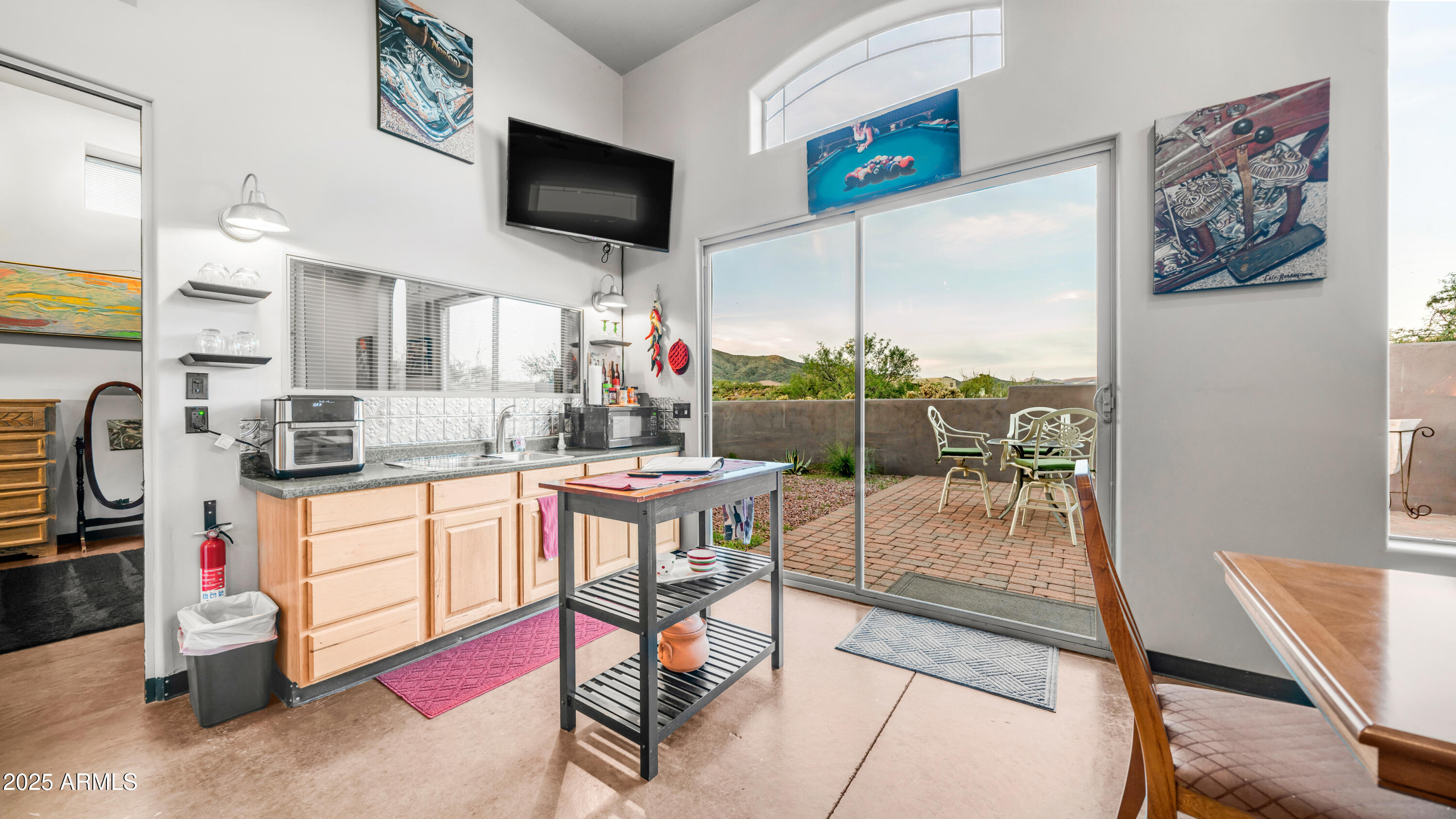 42215 North La Plata Road Scottsdale, AZ 85262 - Photo 57 of 93 a kitchen with stainless steel appliances granite countertop a refrigerator a stove a sink a dining table and chairs with wooden floor